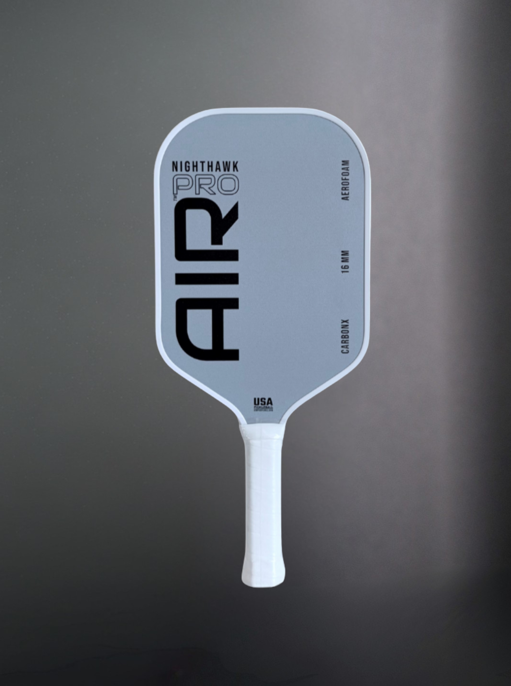 Pickleball paddle with 'Nighthawk Pro' branding on a gray background